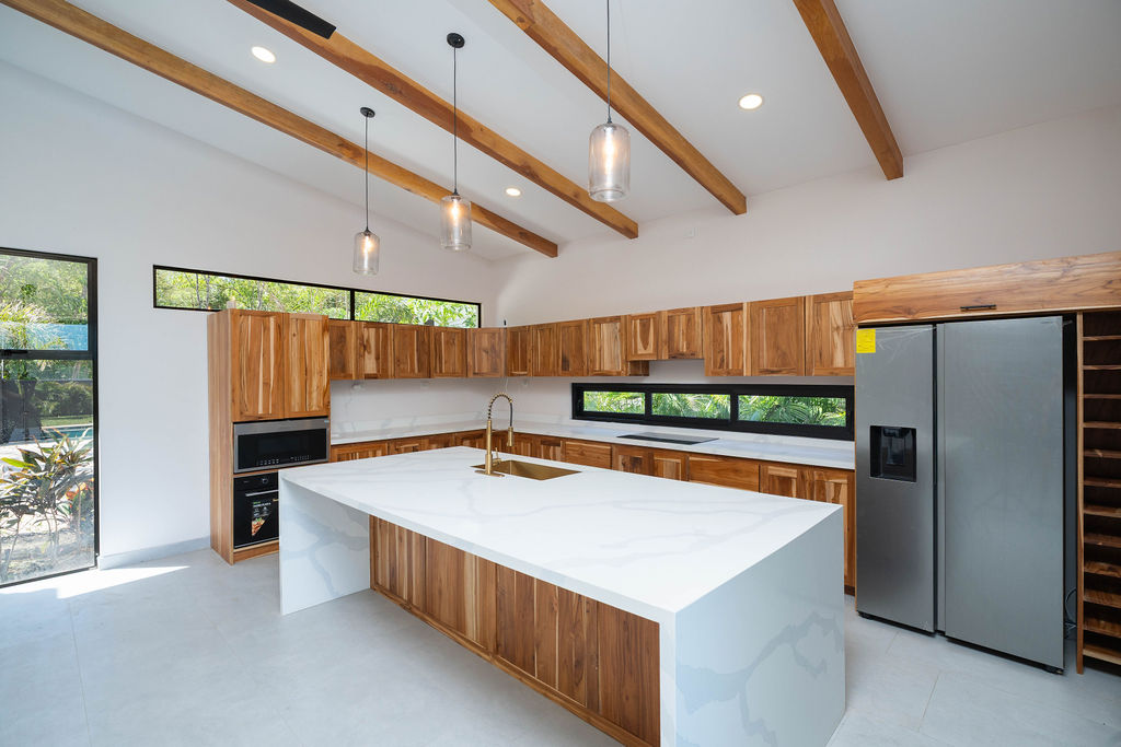 Casa Soma modern kitchen with wood cabinets and quartz countertops – 6 Casa Soma Playa Avellanas | Modern Home for Sale