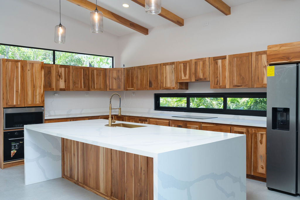 Casa Soma modern kitchen with wood cabinets and quartz countertops 7 Casa Soma Playa Avellanas | Modern Home for Sale